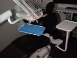 a dentist ' s chair in the corner of the room