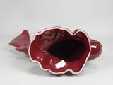 a red vase that has a fish inside of it