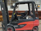 a red fork truck parked in front of a building