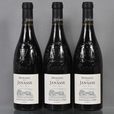 trois bouteilles de vin rouge posées sur une table l'une à côté de l'autre