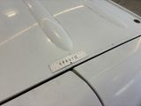 a sticker on the hood of a white car