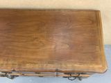 a small wooden table with a drawer on top of it
