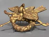 brass sculpture of two birds on a branch with a bird on top