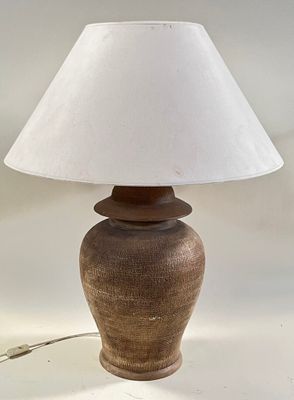 a lamp that is sitting on a table with a white shade on it
