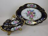 a plate with a lid and a bowl with flowers on it