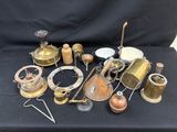 many different types of brass items on a black table