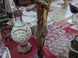 une statue représentant une femme tenant une balle posée sur une table