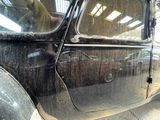 a black car that is parked in a garage