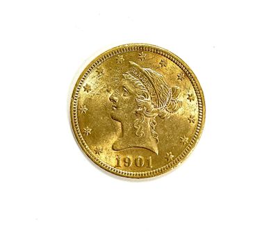 a close up of a gold coin on a white surface