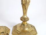 pair of antique brass candlesticks on a white background