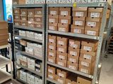 shelves of boxes and boxes are stacked on top of each other in a warehouse
