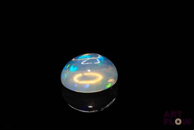 an image of a white oplite in the dark