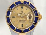 une montre Rolex dorée et bleue sertie de diamants