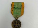 a close up of a medal on a white surface