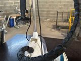 someone is using a steam iron to iron clothes on a table