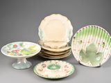 many plates and bowls that are sitting on a table