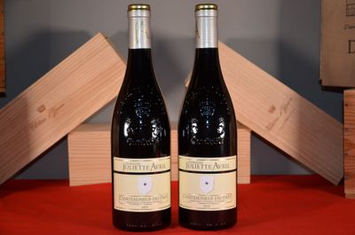 two bottles of wine sitting on a table next to each other