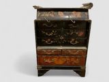 a small wooden cabinet with a drawer on it