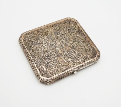 an antique silver cigarette case on a white background