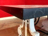 a close up of a table with a red wall in the background