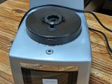 a silver and black stove top on a wooden table