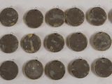 a close up of a bunch of coins on a white surface