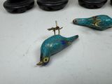 three birds that are sitting next to each other on a table