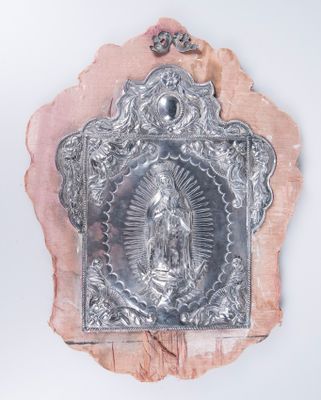 an image of a silver plate with an image of the virgin on it