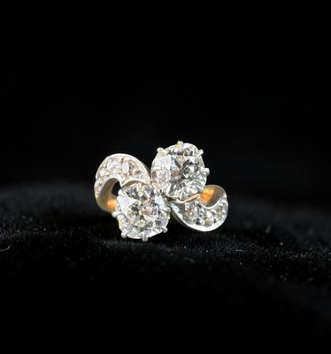 a pair of diamond earrings on a black background