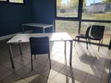 two chairs and a table in a room with a large window