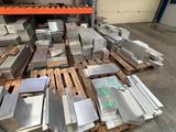 many pieces of metal on a pallet in a warehouse