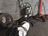 a motorcycle that is parked next to a cart