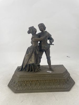 statue of a man and a woman dancing on a pedestal