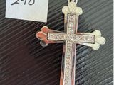 a close up of a cross on a table with a price tag