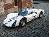 a white and blue race car parked in front of a brick building