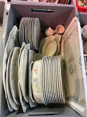 a lot of plates and bowls in a box