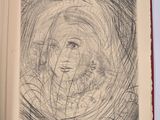 an open book with a drawing of a woman ' s face on it