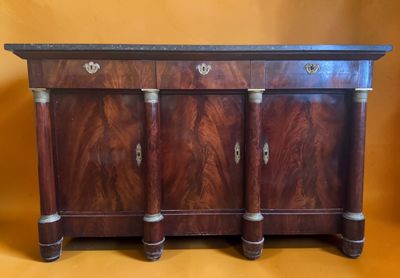 a wooden sideboard with three drawers and a marble top