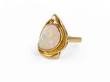 a gold ring with a white oplite stone in the center
