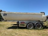 un gros camion blanc garé dans l'herbe