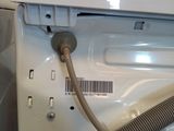 a white dishwasher with a hose attached to it