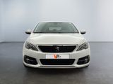 the front view of a white car in a white room