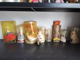 a shelf that has a bunch of dolls and other items on it