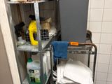 a trash can and a trash can on a cart in a bathroom