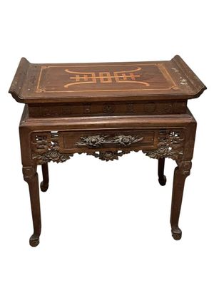 a wooden table with writing on it on it