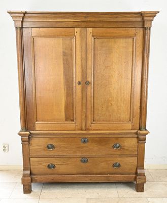 a wooden armoire with two drawers on top of it