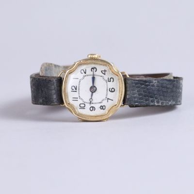 a close up of a wrist watch with roman numerals on it