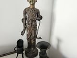 a statue that is sitting on a table next to other items