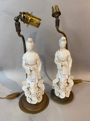 pair of antique chinese figurines with a lamp on a table