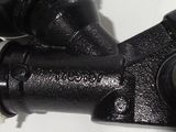 a close up of a black pipe on a white surface